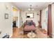 Living area with wood floors, lounge chair, and french doors to the exterior at 1035 Nw Wexford Pl # D3, Concord, NC 28027