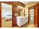 Bright bathroom with a double sink vanity and decorative wallpaper at 11 Courageous St, Lake Wylie, SC 29710