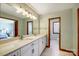 Well-lit primary bathroom with a double sink vanity, marble floors, and a separate toilet room at 11 Courageous St, Lake Wylie, SC 29710