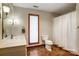 Bathroom featuring vanity, lighting, tile floors, and a wooden framed window with a white pleated shade at 11 Courageous St, Lake Wylie, SC 29710