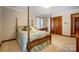 Bedroom with a four-poster bed, a window with a view, a desk, and a closet at 11 Courageous St, Lake Wylie, SC 29710