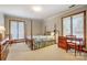 Bedroom with a four-poster bed, a desk and chair by the window, and neutral-colored walls and carpet at 11 Courageous St, Lake Wylie, SC 29710