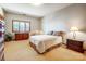Comfortable bedroom with neutral colors, carpeted floors, and natural light from a large window at 11 Courageous St, Lake Wylie, SC 29710