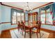 Formal dining room with hardwood floors, light-blue walls, a large window, and dining table seating for six at 11 Courageous St, Lake Wylie, SC 29710