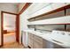 Convenient laundry room with a washer, dryer, sink, and wooden shelving at 11 Courageous St, Lake Wylie, SC 29710
