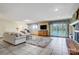 Spacious living room with tile flooring, fireplace, furniture, and a sliding glass door that views the lake at 11 Courageous St, Lake Wylie, SC 29710
