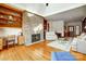 Living room featuring a brick fireplace, built-in bookshelves, and hardwood floors at 11 Courageous St, Lake Wylie, SC 29710