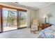 View from the Primary bedroom to a large deck with an outdoor kitchen and seating, overlooking the lake at 11 Courageous St, Lake Wylie, SC 29710