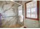 Walk-in shower with marble walls, glass door, and decorative shower tile at 11 Courageous St, Lake Wylie, SC 29710