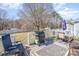 Cozy back deck featuring a grill, outdoor seating, and a peaceful backyard setting at 110 Weeping Willow Way, Gastonia, NC 28052