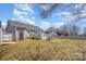 Spacious backyard showcasing the home's exterior, a deck, and mature trees at 110 Weeping Willow Way, Gastonia, NC 28052