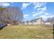 Expansive backyard with a fence, a storage shed, and a deck, providing plenty of space for activities at 110 Weeping Willow Way, Gastonia, NC 28052
