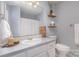 Bright bathroom featuring a white vanity, gray walls, decorative shelves, and updated fixtures at 110 Weeping Willow Way, Gastonia, NC 28052