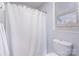 Clean bathroom with white shower curtain, toilet, and window providing natural light at 110 Weeping Willow Way, Gastonia, NC 28052