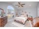 Bright, spacious bedroom featuring a large arch window, ceiling fan, and neutral decor at 110 Weeping Willow Way, Gastonia, NC 28052