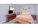 Bedroom featuring warm tones, wood furniture, and a comfortable bed at 110 Weeping Willow Way, Gastonia, NC 28052