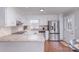 Bright kitchen with white cabinets, stainless steel refrigerator, and stone countertops at 110 Weeping Willow Way, Gastonia, NC 28052