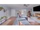 Comfortable living room with hardwood floors, large sofa, fireplace, and natural light from the window at 110 Weeping Willow Way, Gastonia, NC 28052