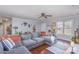 Inviting living room with a large gray sectional sofa, hardwood floors, and neutral paint, creating a relaxing atmosphere at 110 Weeping Willow Way, Gastonia, NC 28052