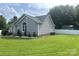 A well-kept home with a green lawn, surrounded by a white fence for privacy at 110 Weeping Willow Way, Gastonia, NC 28052