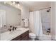 Bathroom with marble countertops, modern fixtures, and a shower with a white shower curtain at 121 Wonderwood Dr, Charlotte, NC 28211