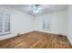 Spacious bedroom featuring hardwood floors, white trim, neutral walls, and a ceiling fan at 121 Wonderwood Dr, Charlotte, NC 28211