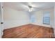 Empty bedroom with hardwood floors, neutral walls, and two windows at 121 Wonderwood Dr, Charlotte, NC 28211