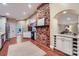 Spacious kitchen featuring custom brickwork, terracotta tile floors and stainless appliances at 121 Wonderwood Dr, Charlotte, NC 28211