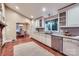 Bright kitchen with white cabinets, stainless steel appliances, and attached dining space at 121 Wonderwood Dr, Charlotte, NC 28211