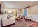 Comfortable living room featuring a decorative rug, stylish furniture, and natural lighting at 121 Wonderwood Dr, Charlotte, NC 28211