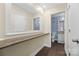Hallway leading to bathroom with marble-look countertop and blue patterned wallpaper at 1323 Queens Rd # 218, Charlotte, NC 28207
