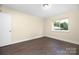 Cozy bedroom with natural light, showcasing wood-look flooring and simple decor at 1323 Queens Rd # 218, Charlotte, NC 28207