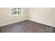 Sunlit bedroom with wood-look floors and minimalist decor, showcasing a view at 1323 Queens Rd # 218, Charlotte, NC 28207