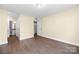 Spacious bedroom with wood-look flooring and neutral paint, filled with natural light at 1323 Queens Rd # 218, Charlotte, NC 28207