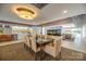 Community dining room with seating for eight, kitchen, and fireplace at 1323 Queens Rd # 218, Charlotte, NC 28207