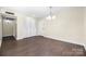 Open-concept living room with hardwood floors and a closet at 1323 Queens Rd # 218, Charlotte, NC 28207