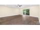 Spacious living room with wood floors and a sliding glass door at 1323 Queens Rd # 218, Charlotte, NC 28207