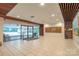 Spacious building lobby with tiled floor, wood details and glass doors to the exterior at 1323 Queens Rd # 218, Charlotte, NC 28207