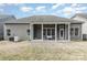 Back exterior view of the home featuring a covered porch and well-maintained yard at 15727 Kiser Corner Ln, Davidson, NC 28036