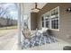 Relaxing back porch with comfortable seating and a ceiling fan at 15727 Kiser Corner Ln, Davidson, NC 28036