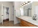 Bathroom featuring a vanity with sink, large mirror, and access to the walk-in closet at 15727 Kiser Corner Ln, Davidson, NC 28036