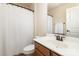 Clean bathroom featuring a shower with curtain, vanity with sink, and a toilet at 15727 Kiser Corner Ln, Davidson, NC 28036