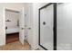 Modern bathroom with a sleek glass enclosed shower and neutral tile flooring at 15727 Kiser Corner Ln, Davidson, NC 28036