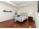 Comfortable bedroom featuring hardwood floors, a tray ceiling, and natural light at 15727 Kiser Corner Ln, Davidson, NC 28036