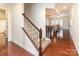 View of the hardwood entry and staircase leading up to the second floor and the living room beyond at 15727 Kiser Corner Ln, Davidson, NC 28036