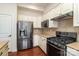 Kitchen featuring stainless steel appliances, granite countertops, and white cabinets at 15727 Kiser Corner Ln, Davidson, NC 28036