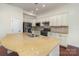 Kitchen featuring a granite island, white cabinets, stainless steel appliances, and hardwood floors at 15727 Kiser Corner Ln, Davidson, NC 28036