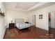 Spacious main bedroom with hardwood floors, tray ceiling, and walk-in closet at 15727 Kiser Corner Ln, Davidson, NC 28036