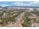 Aerial view of a residential neighborhood with lush greenery and a lake in the distance at 16506 Doves Canyon Ln, Charlotte, NC 28278