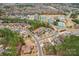 Aerial view of a neighborhood with mature trees, community tennis courts, and a pool at 16506 Doves Canyon Ln, Charlotte, NC 28278